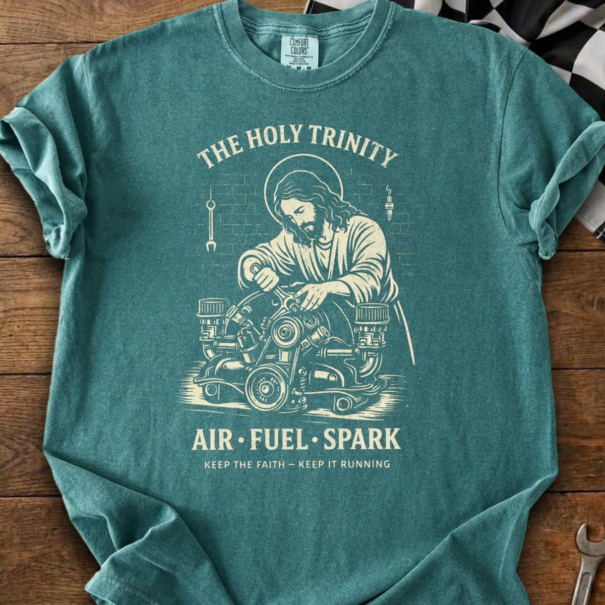Jesus working on an engine with text "The Holy Trinity Air Fuel Spark".
