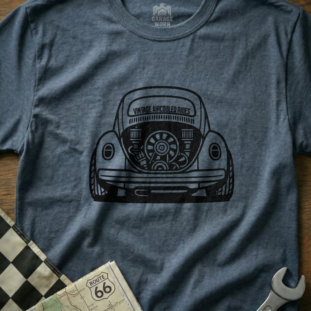 T-shirt with a black graphic of a vintage Volkswagen Beetle's rear engine and "Garage Worn Vintage Aircooled Rides" text.