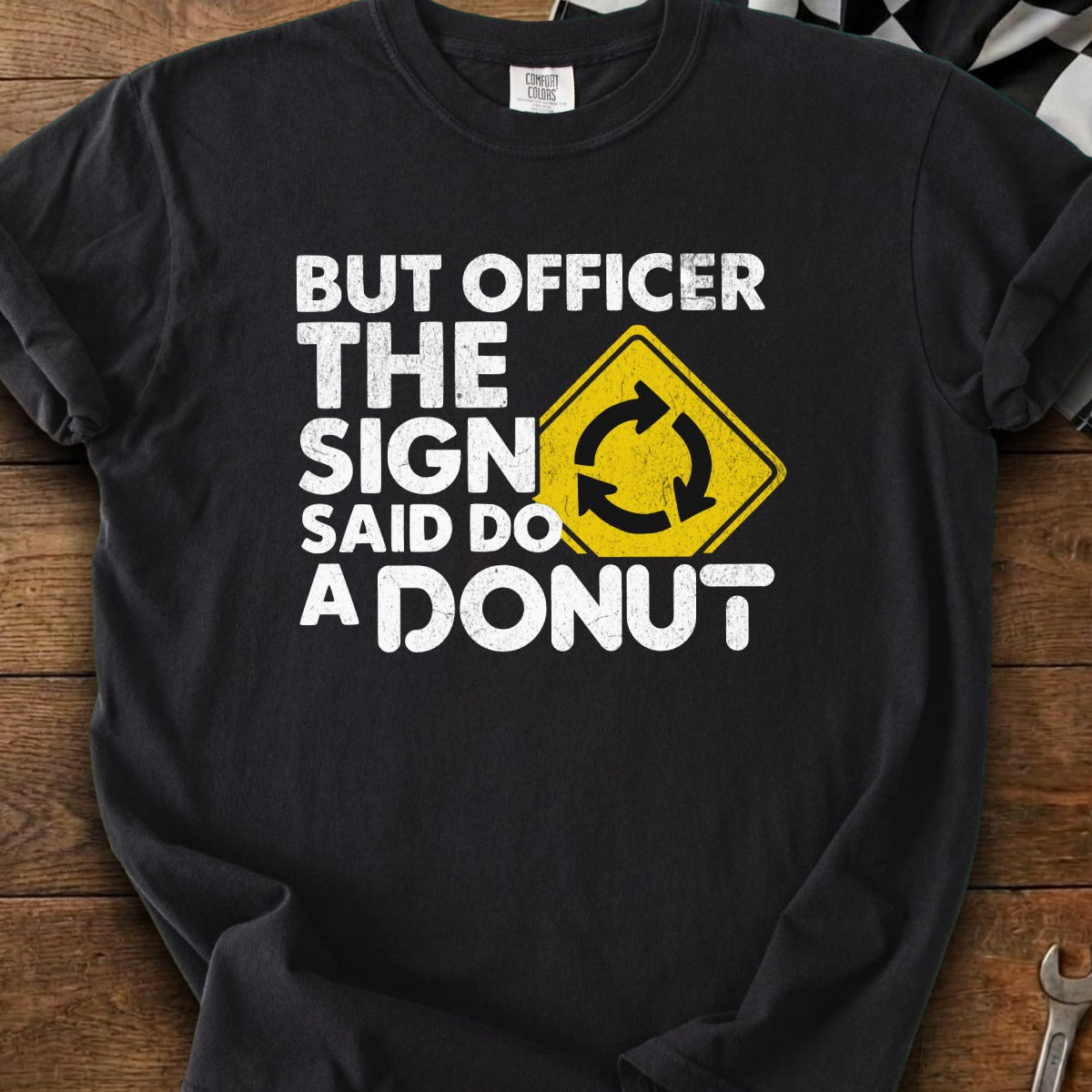 Black t-shirt with white text saying "But officer the sign said do a donut".