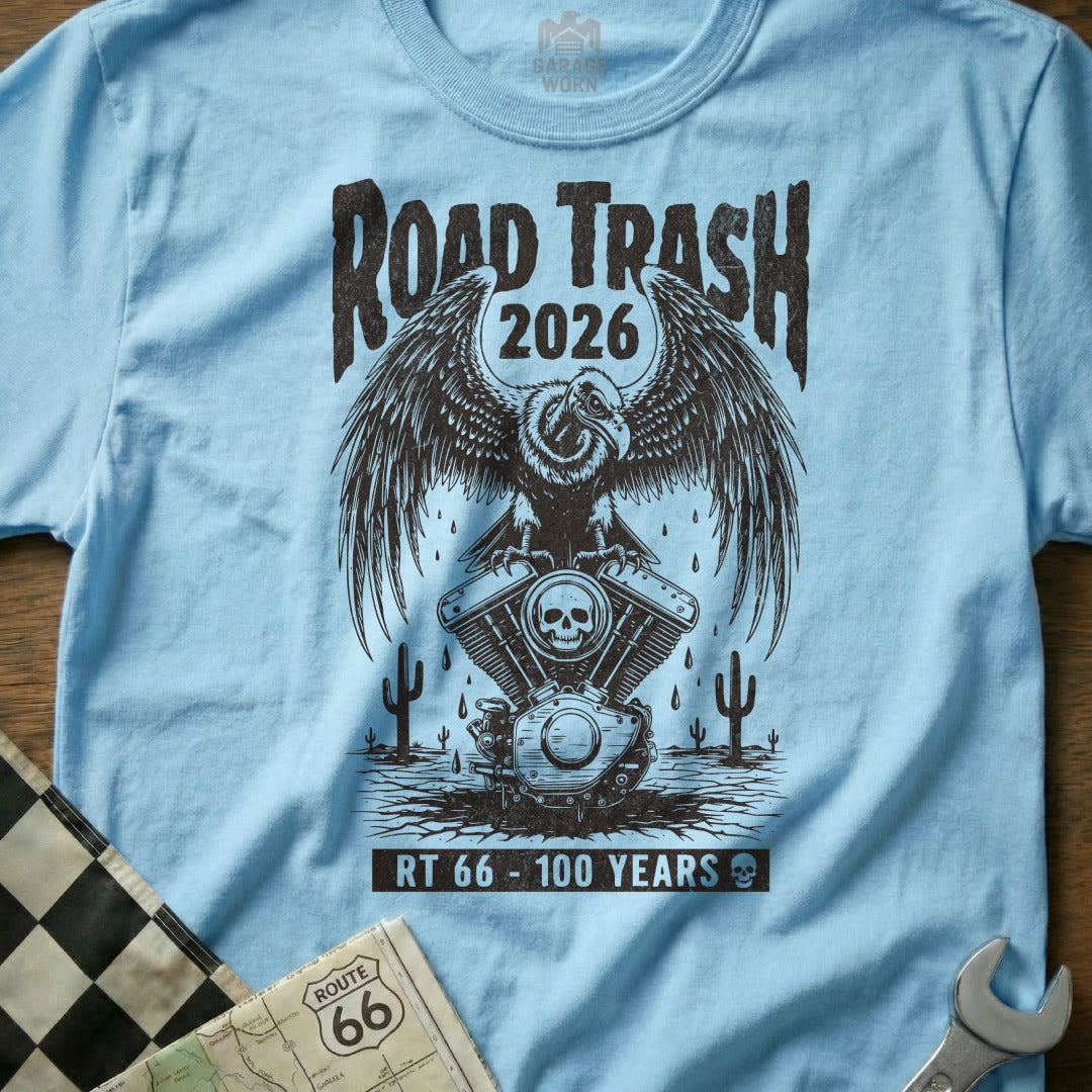 Light blue t-shirt with a vintage eagle and engine graphic, "Road Trash 2026" and "Route 66 100 Years".