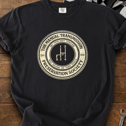 Manual Transmission Preservation Society graphic with gear shift pattern and "Real Drivers Use Three Pedals."