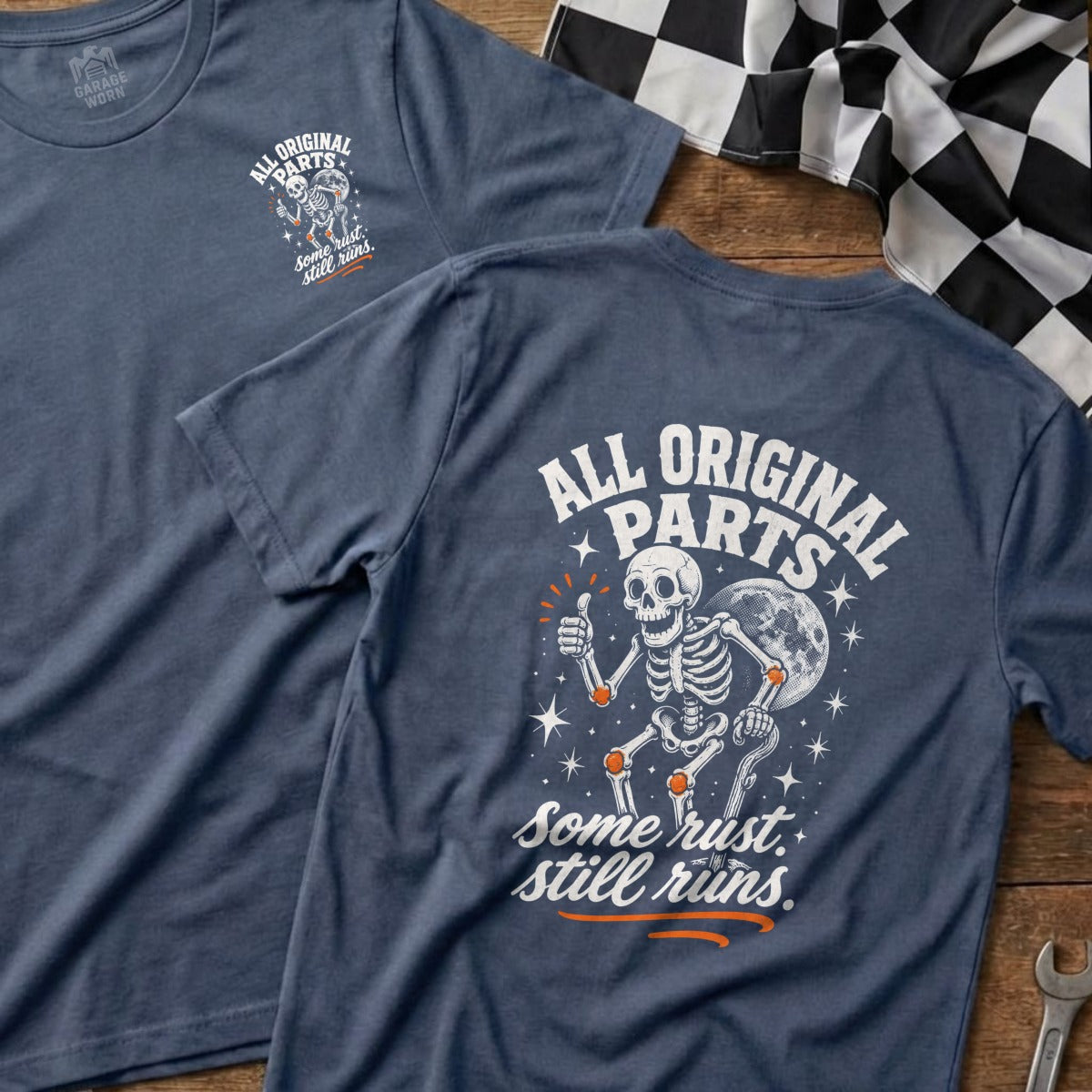 T-shirt with skeleton graphic, moon, stars, and text "All Original Parts. Some rust. Still runs."