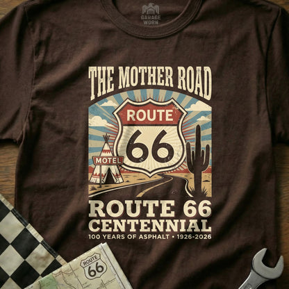 Brown t-shirt graphic with Route 66 centennial logo, motel, and desert scene.