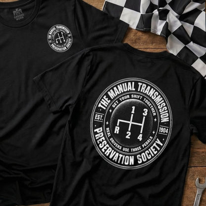 Black t-shirt with "The Manual Transmission Preservation Society" graphic.