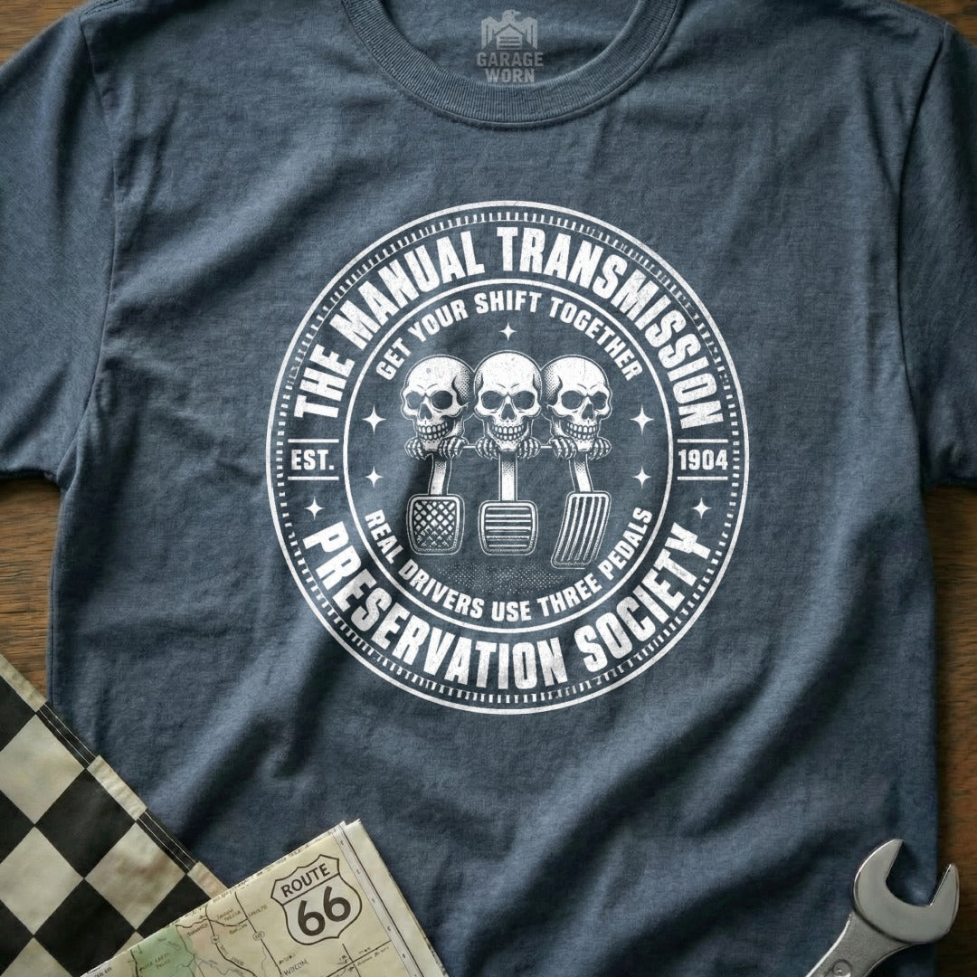 Manual Transmission Preservation Society shirt with skulls on pedals.