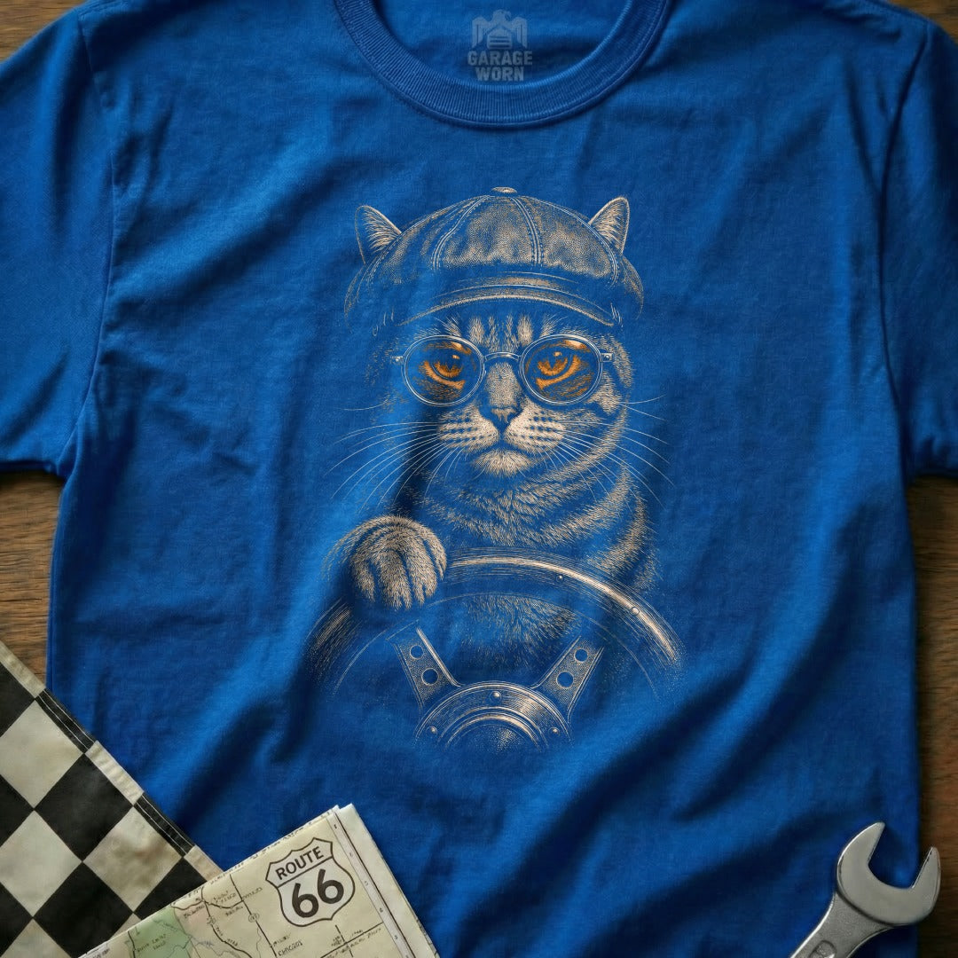 T-shirt graphic of a cat wearing glasses and a cap, driving a car.