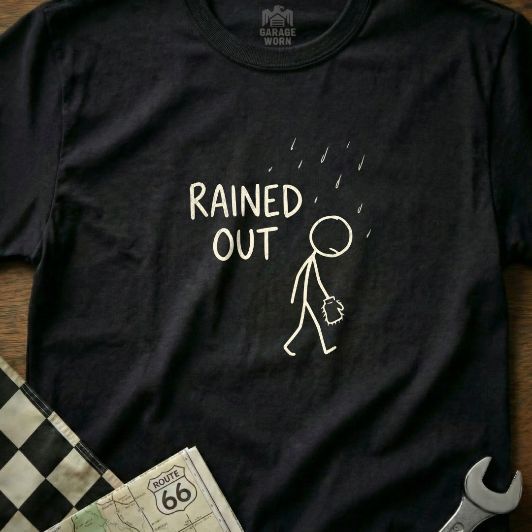 Black t-shirt with a stick figure walking in the rain and text "RAINE D OUT".