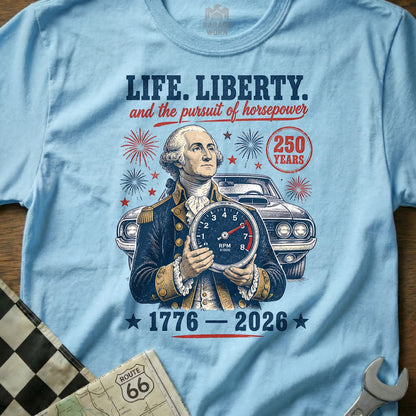 George Washington holds RPM gauge with car, fireworks, and "1776-2026" text.
