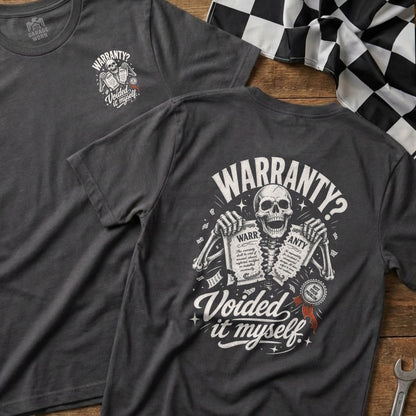 Dark grey t-shirt with skeleton graphic holding warranty papers, text reads "Warranty? Voided it myself."