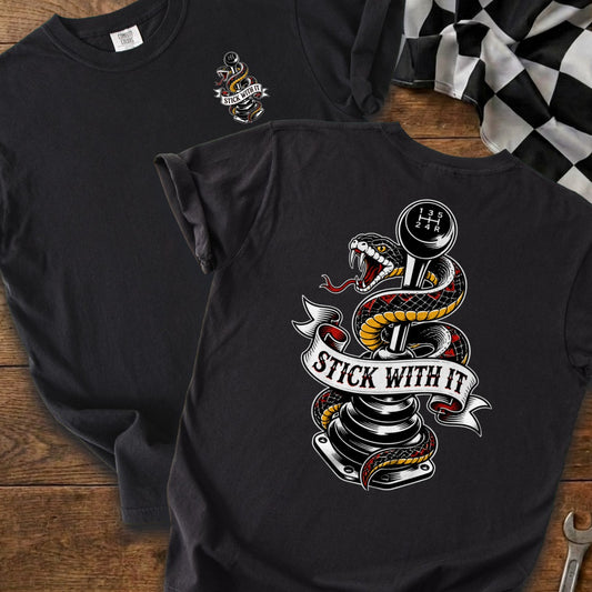 T-shirt featuring a snake coiled around a gear shift with the text "STICK WITH IT".