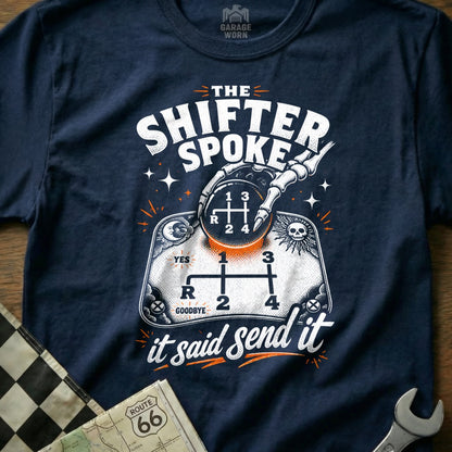 "The Shifter Spoke" graphic tee with a skeleton hand on a gear shift and "it said send it" text.