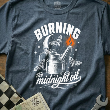 T-shirt graphic: "Burning the midnight oil" with oil can, moths, and moon.