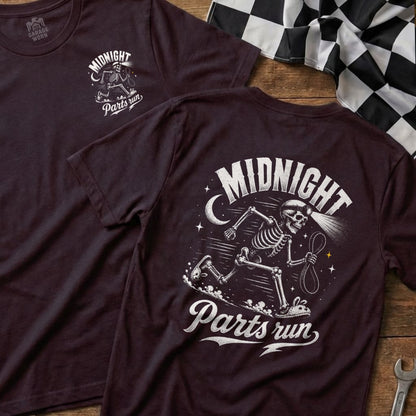Dark graphic t-shirt with a running skeleton, moon, and text "Midnight Parts run".