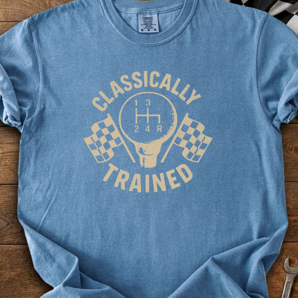 Blue t-shirt with "Classically Trained" text, gearbox, and checkered flags.