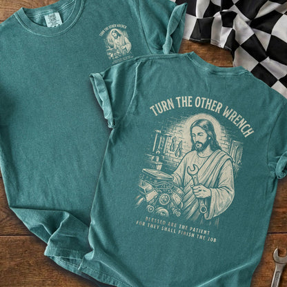 Jesus holding a wrench with tools, engine. "Turn the Other Wrench" text.