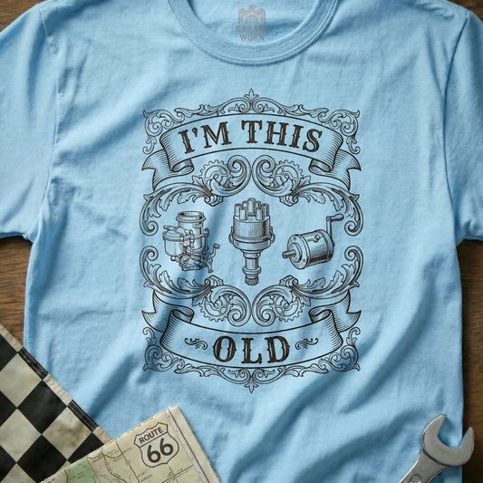 Light blue t-shirt with "I'm This Old" text and vintage car engine parts graphic.