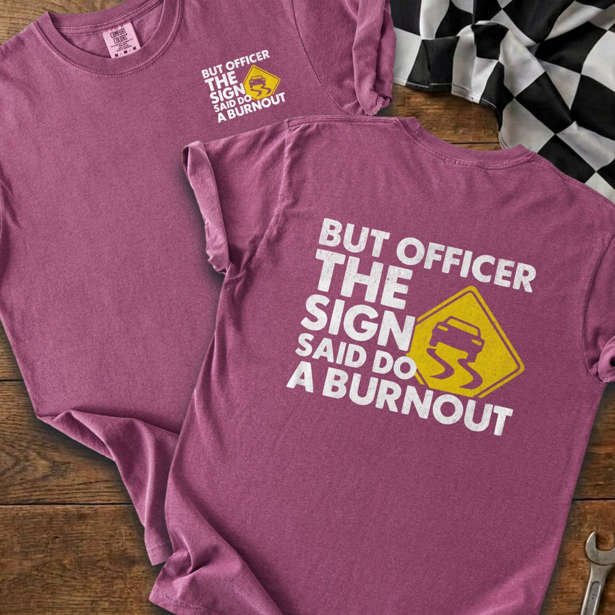 T-shirt with white text "BUT OFFICER THE SIGN SAID DO A BURNOUT" and skid mark graphic.