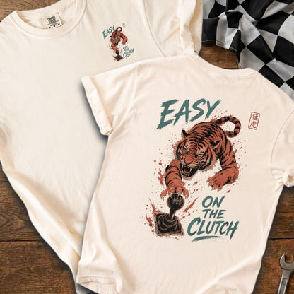 Cream t-shirt with tiger on gear shift and "Easy On The Clutch" text.
