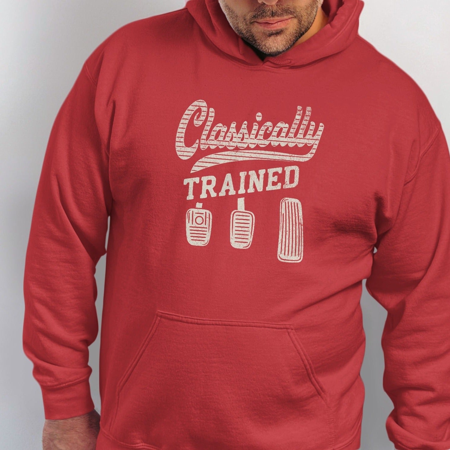 Red hoodie with "Classically TRAINED" and three clutch brake gas pedals.