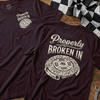Clutch repair t-shirt with "Properly Broken In" text and clutch illustration.
