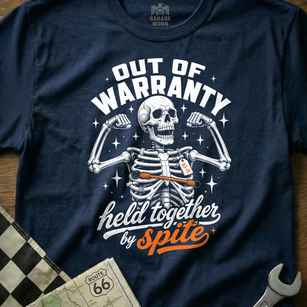 Dark blue t-shirt with a skeleton graphic and text "Out of Warranty" and "Held Together by Spite".