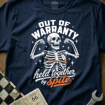 Dark blue t-shirt with a skeleton graphic and text "Out of Warranty" and "Held Together by Spite".