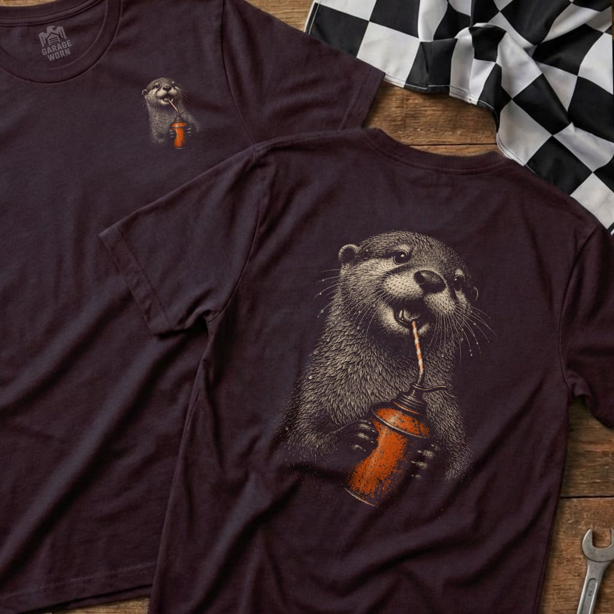 Brown t-shirt with a graphic of an otter drinking from an oil can. Garage Worn logo on front left chest.