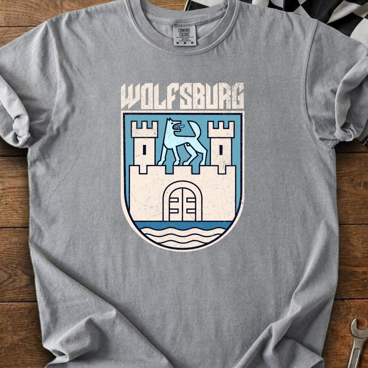 Grey t-shirt with Wolfsburg crest and text, featuring a wolf and castle.