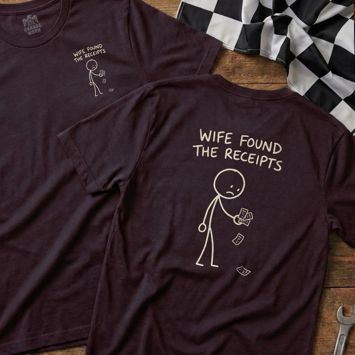 Dark t-shirt with stick figure holding receipts and text "WIFE FOUND THE RECEIPTS".