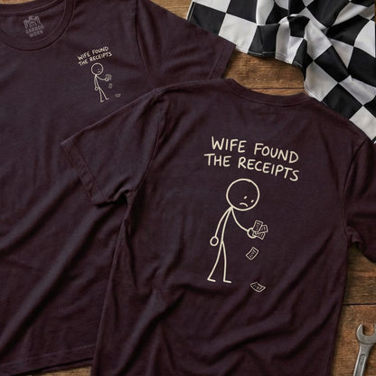 Dark t-shirt with stick figure holding receipts and text "WIFE FOUND THE RECEIPTS".