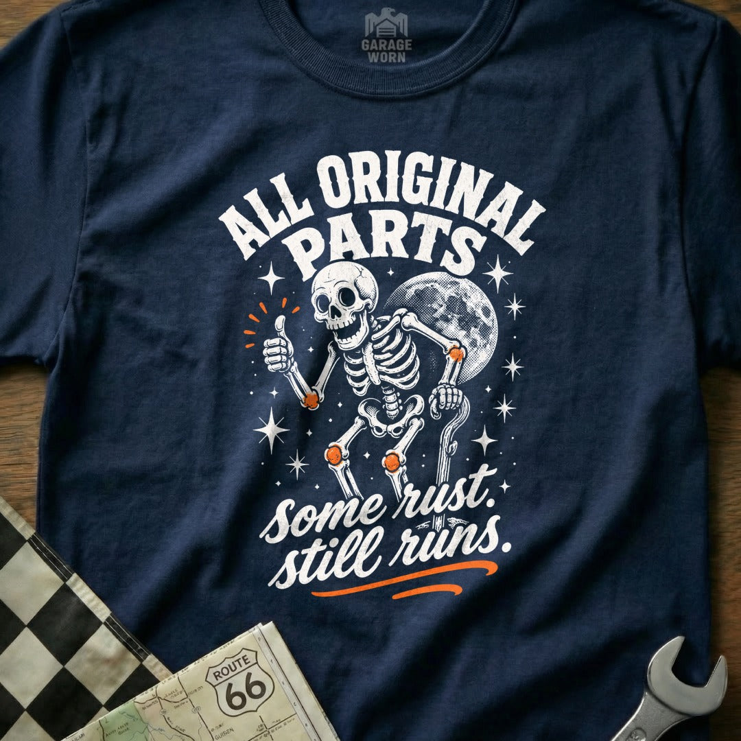 Navy t-shirt with skeleton graphic and text "All Original Parts. Some Rust. Still Runs."
