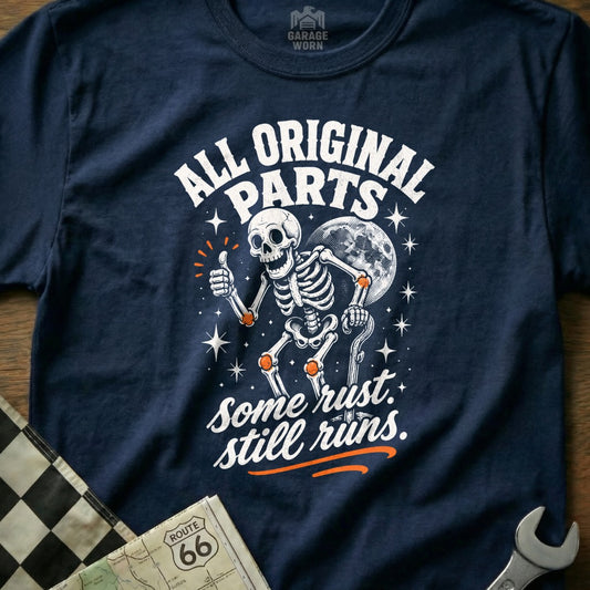Navy t-shirt with skeleton graphic and text "All Original Parts. Some Rust. Still Runs."