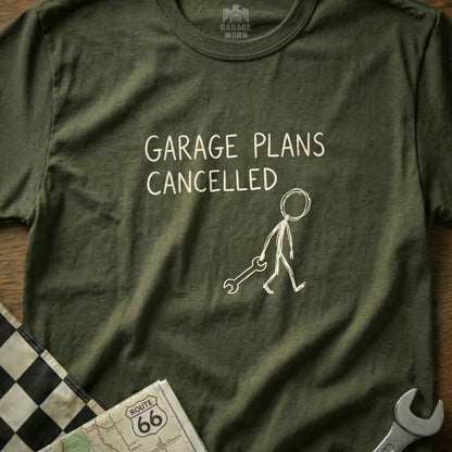 Olive t-shirt with "GARAGE PLANS CANCELLED" text and a stick figure holding a wrench.