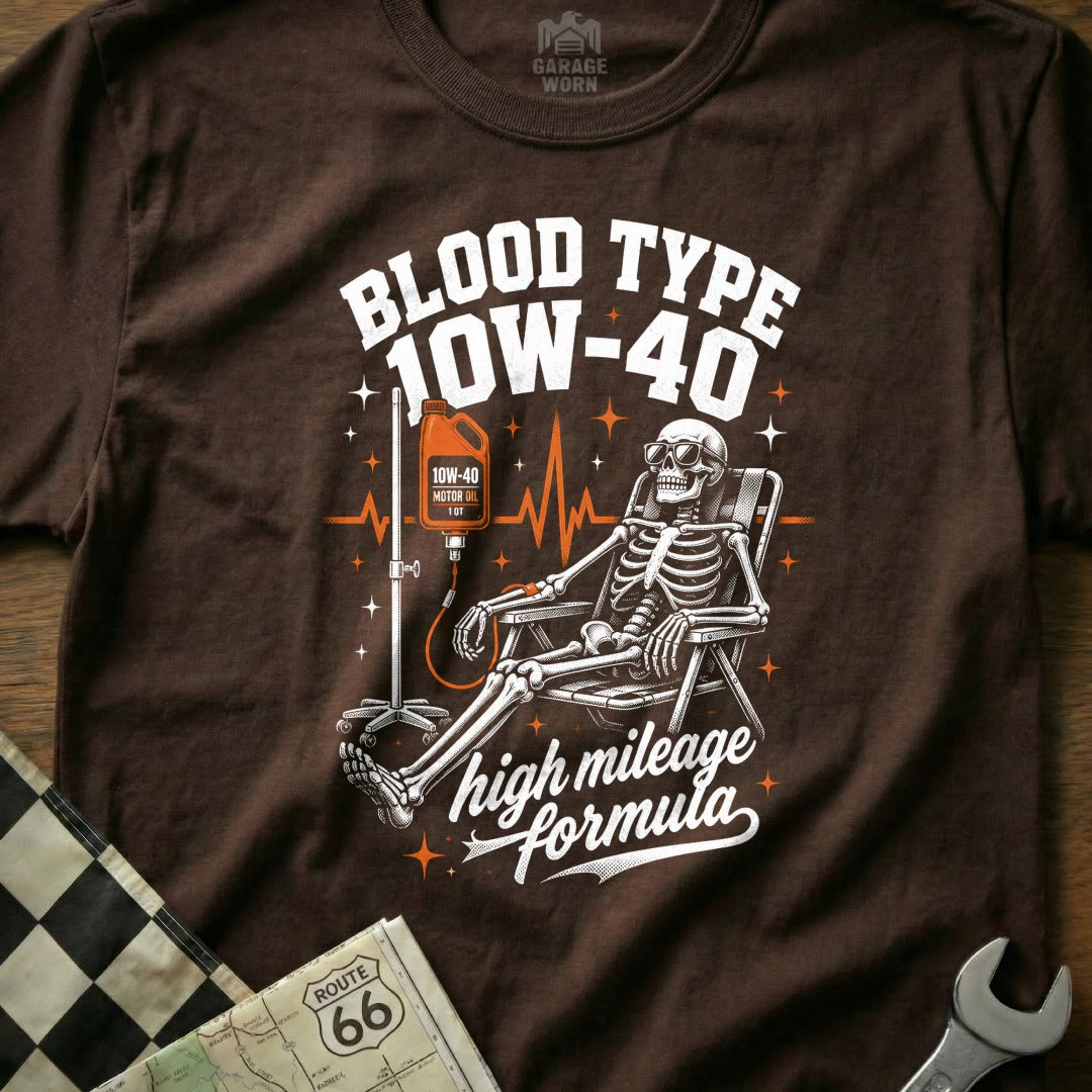 Skeleton receiving an IV bag labeled 10W-40 motor oil, with text "Blood Type 10W-40" and "high mileage formula".