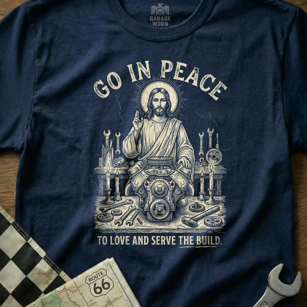 Jesus working on an engine, with text "Go in Peace" and "To Love and Serve the Build."