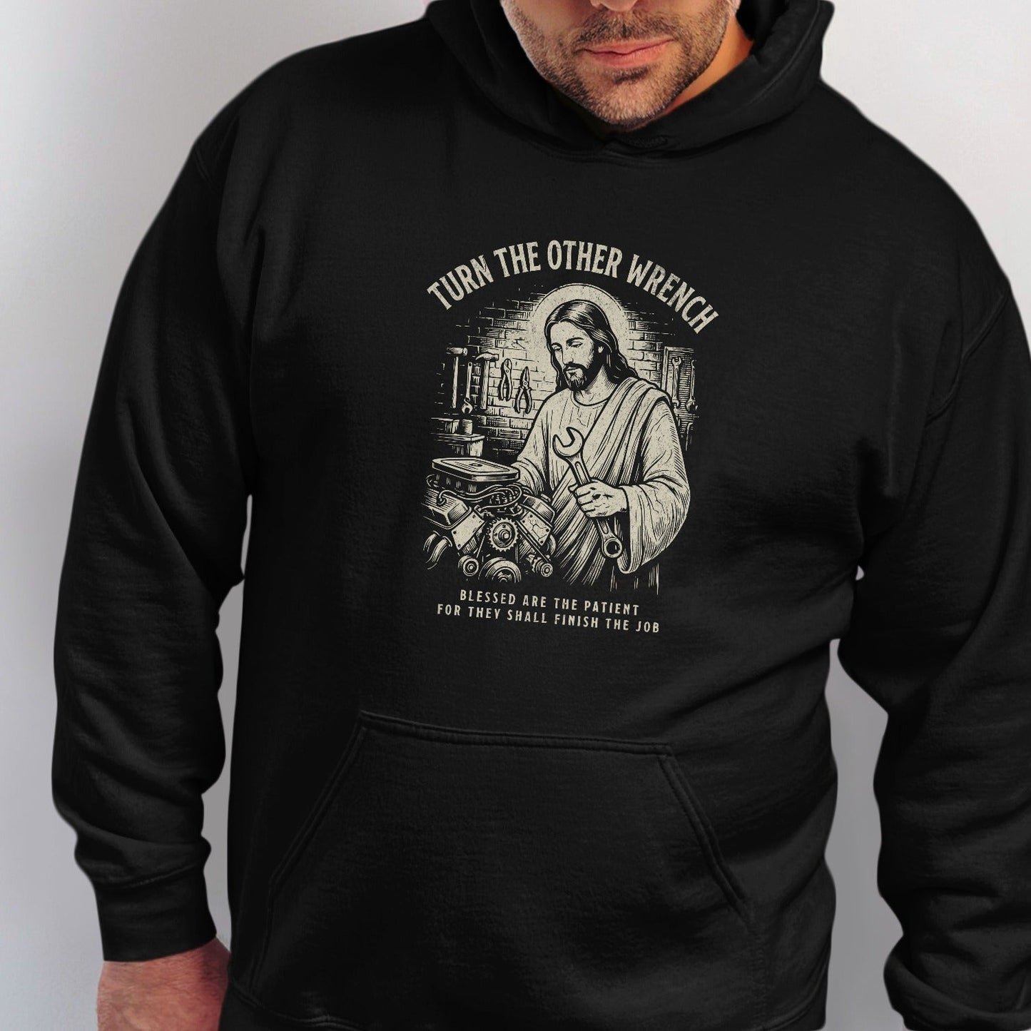 Black t-shirt with Jesus holding a wrench and the text "Turn the other wrench."