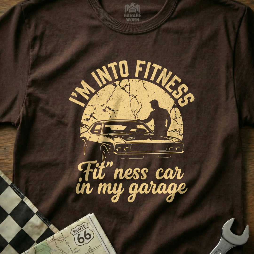 Brown t-shirt with "I'm Into Fitness, Fit'ness car in my garage" text.