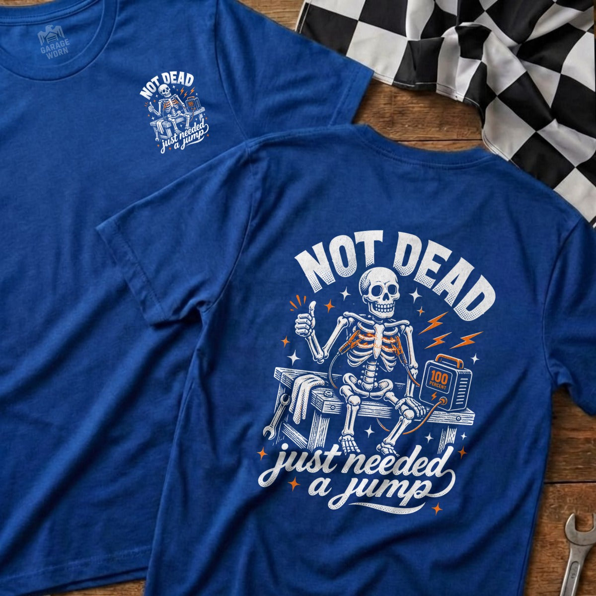Blue t-shirt with skeleton graphic reading "Not Dead Just Needed a Jump".