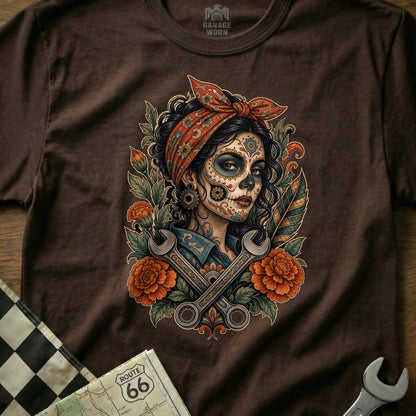 Brown t-shirt with Day of the Dead skull woman graphic, wrenches, and flowers.