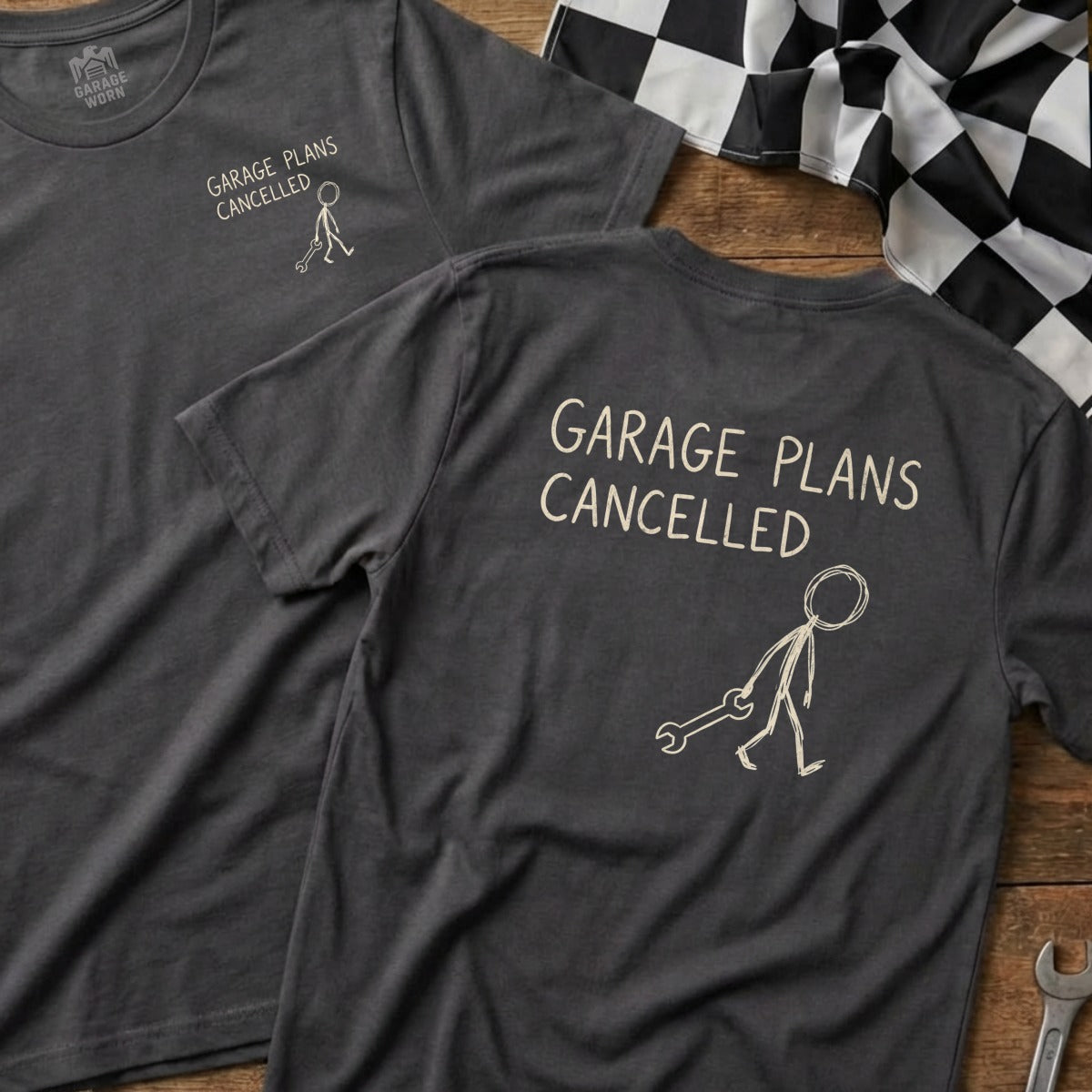 Dark gray t-shirt with "GARAGE PLANS CANCELLED" and stick figure with wrench.