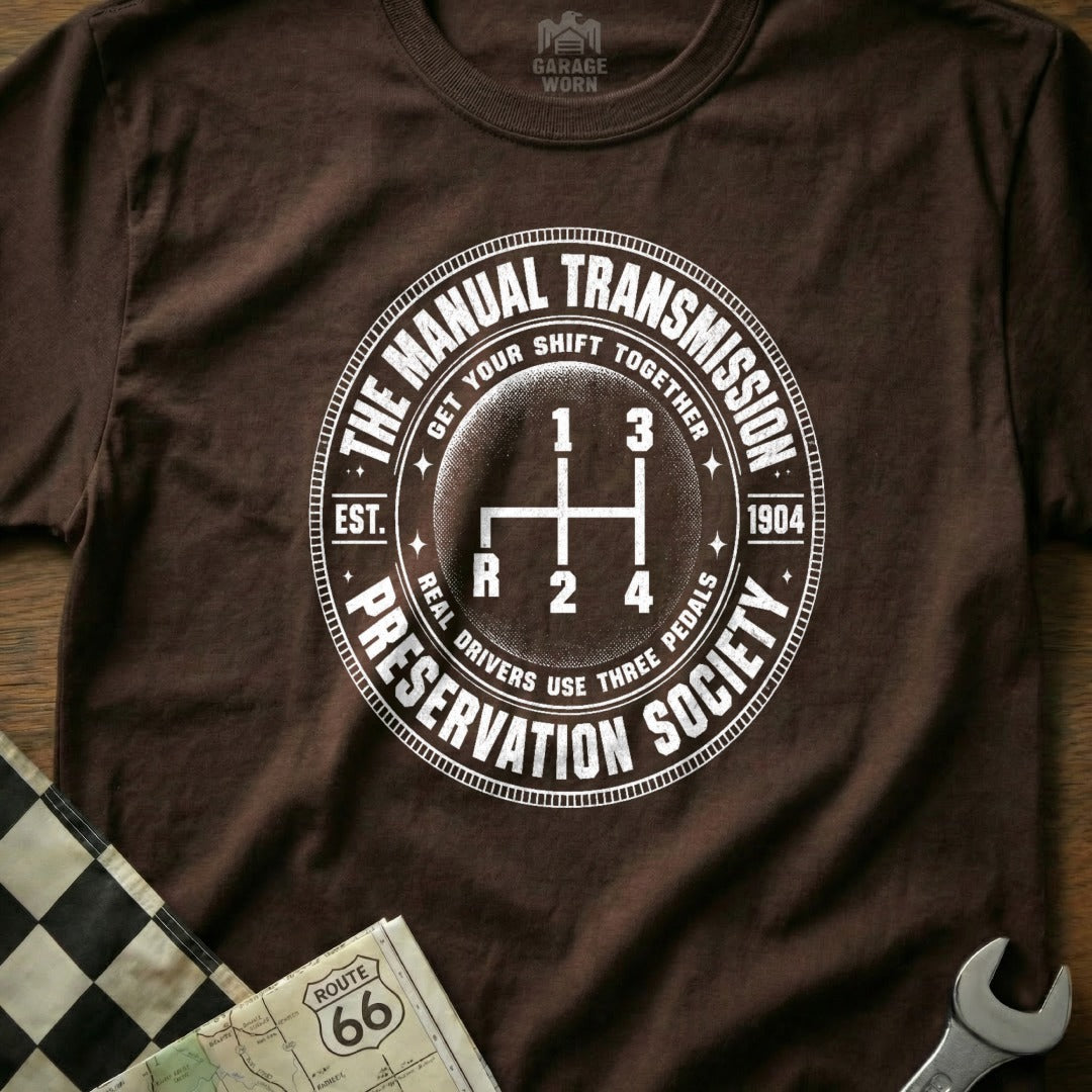 Brown t-shirt with "The Manual Transmission Preservation Society" circle logo.