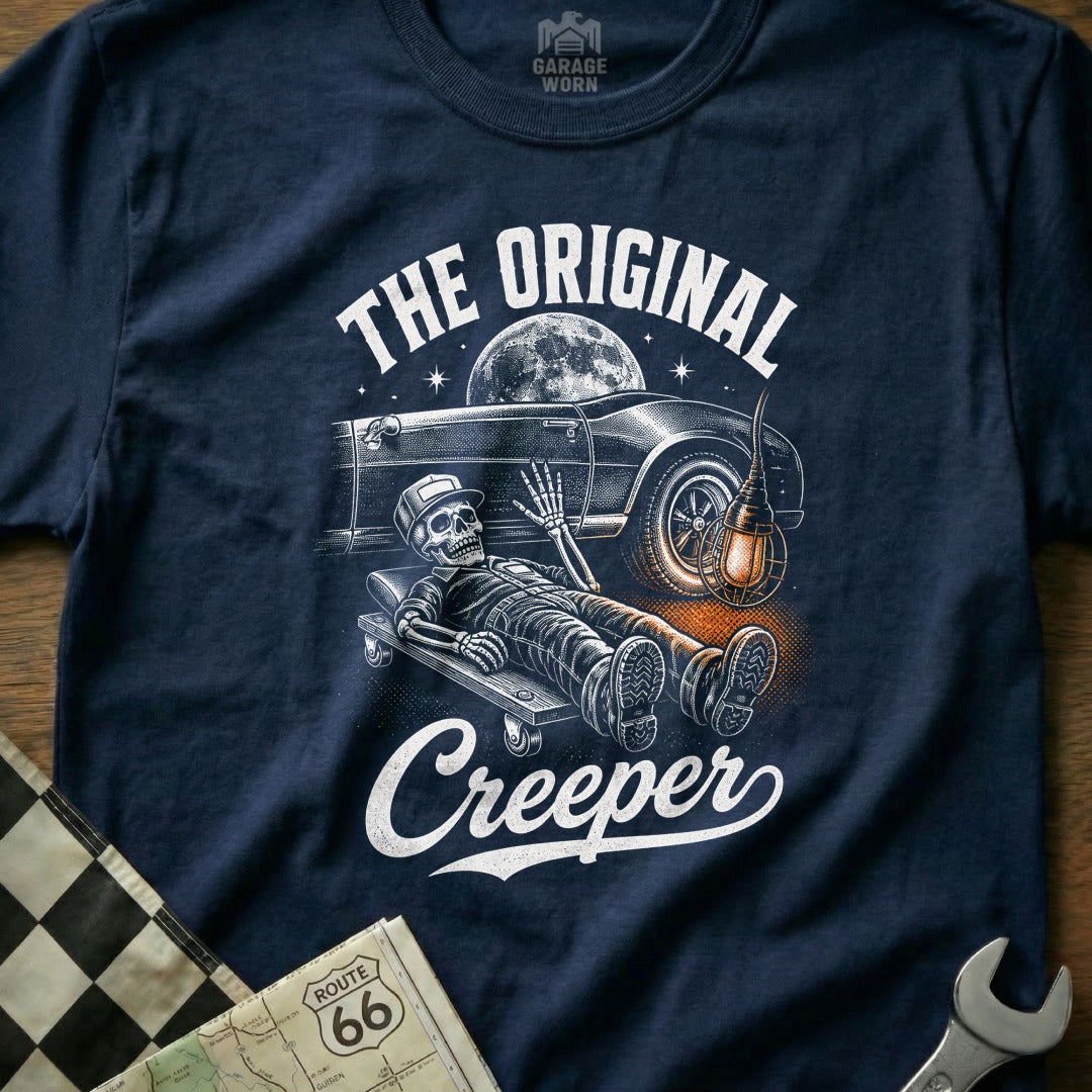 Skeleton on creeper under classic car with text "The Original Creeper".