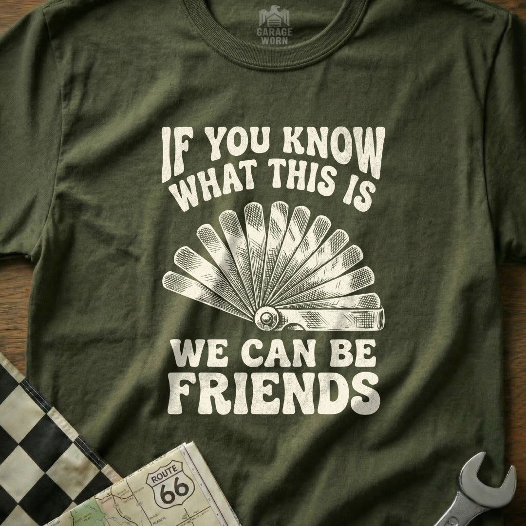 Olive green t-shirt with white text "If you know what this is We can be friends" and wrench graphic.