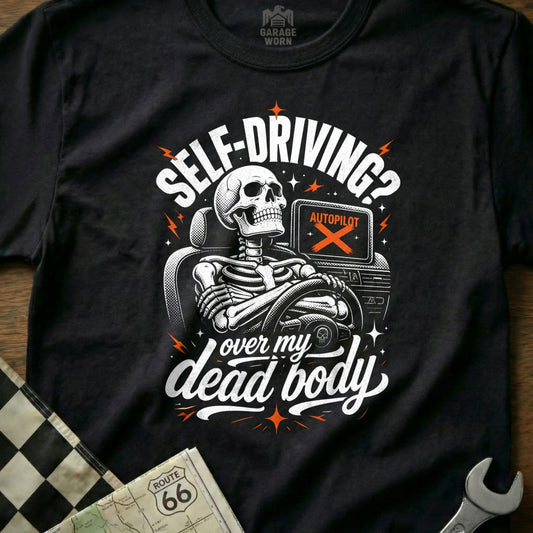 Black t-shirt graphic with skeleton driving, "Self-Driving? Over my dead body."