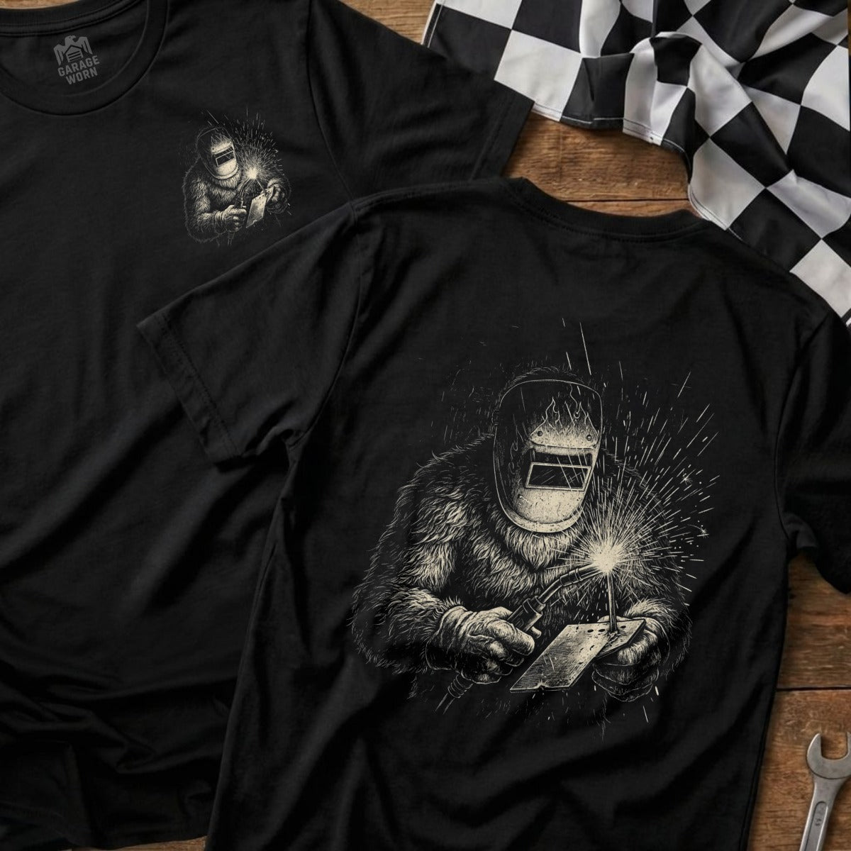 Black t-shirt with a graphic of a welder wearing a helmet.