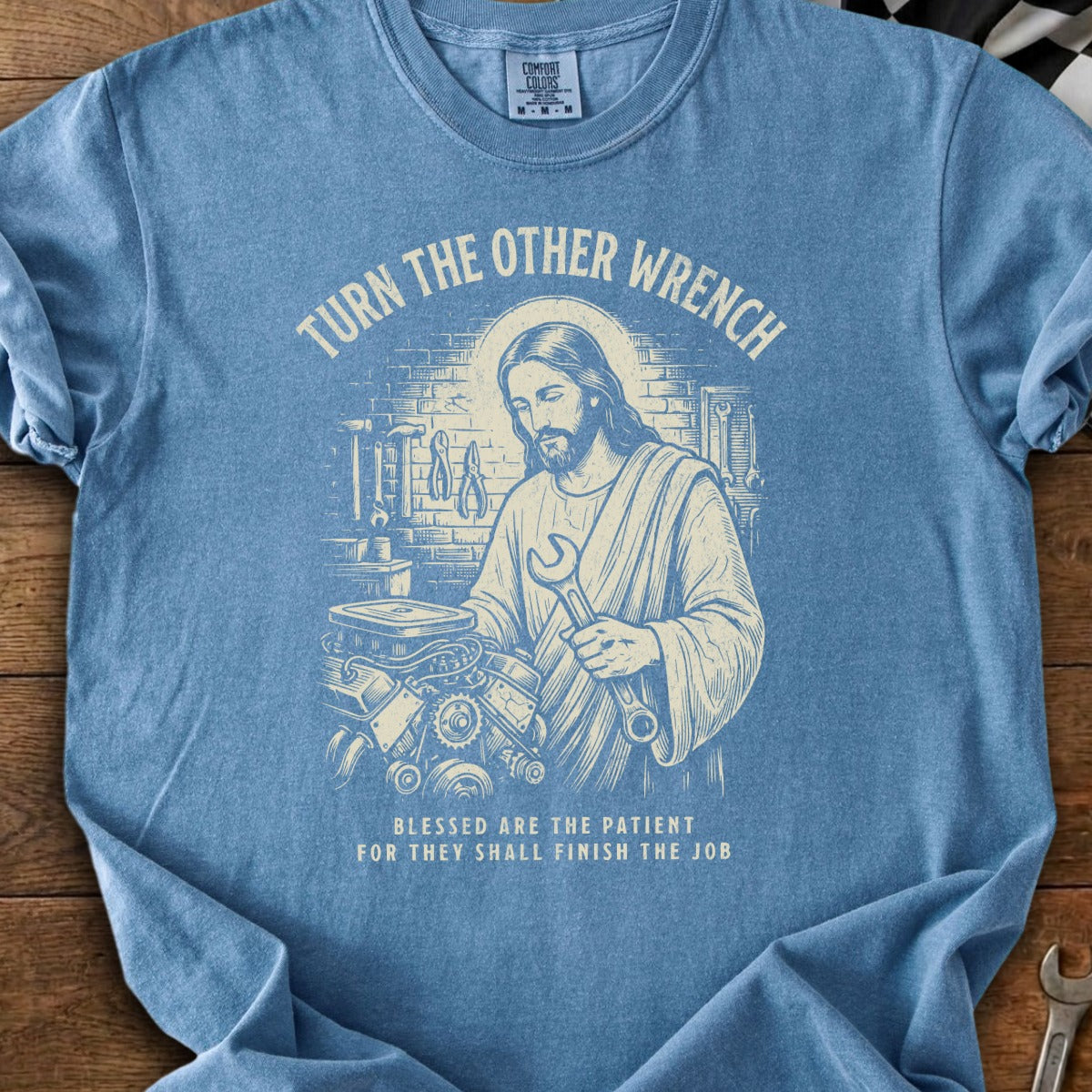 Jesus working on an engine with wrench, "Turn the Other Wrench" and blessed are the patient quote.