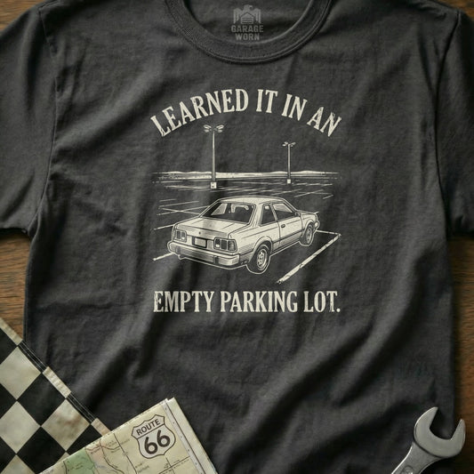 Graphic tee with car in empty parking lot and text "Learned It In An Empty Parking Lot."