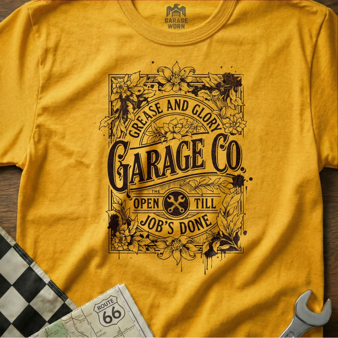 Yellow t-shirt with "Grease and Glory Garage Co." text and floral accents.