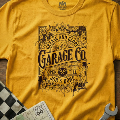 Yellow t-shirt with "Grease and Glory Garage Co." text and floral accents.