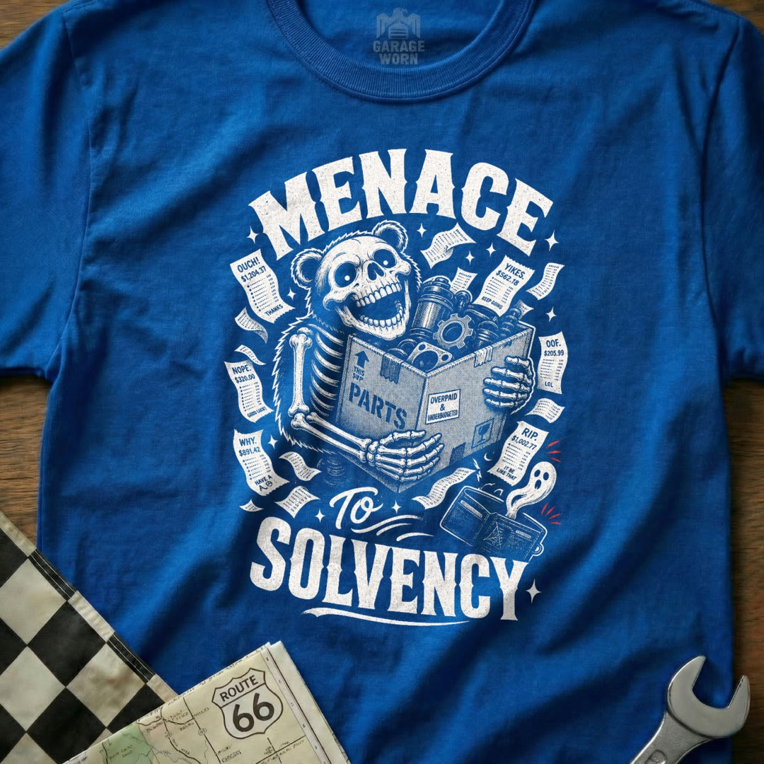 Blue t-shirt with skeleton holding box of "PARTS" and bills labeled "Menace To Solvency".